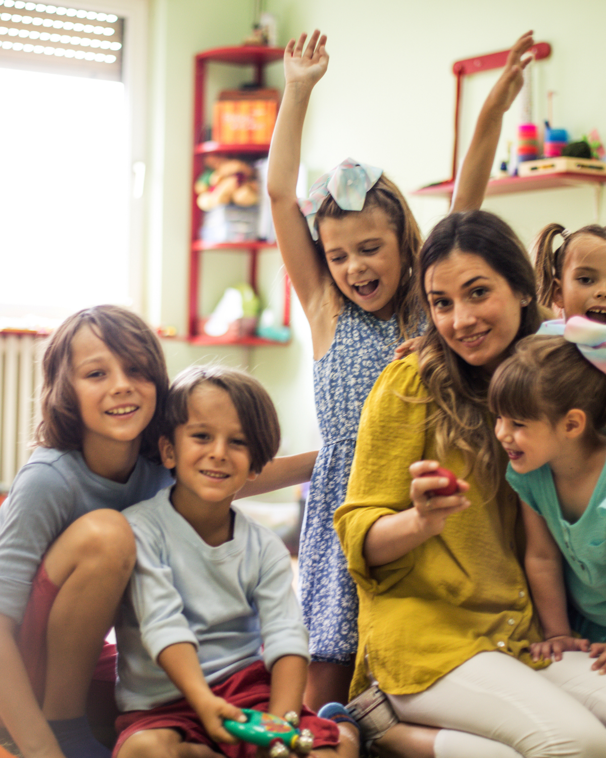 A early childhood educator teaching some happy children